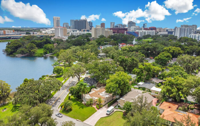 Aerial view of Lake Conway real estate with lakefront homes and downtown Orlando skyline in the background