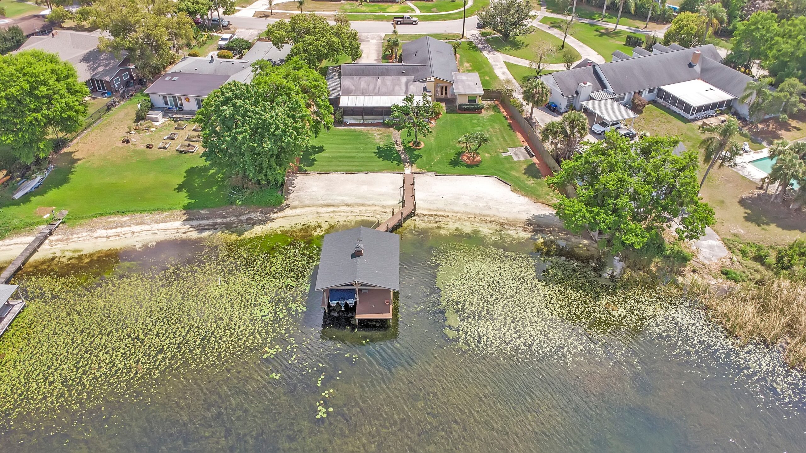 Lakefront home and covered boat dock on Lake Holden in the Lake Holden Shores neighborhood of Orlando